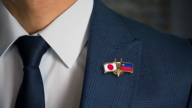 商人走向相机与朋友国家国旗别针日本-列支敦士登视频素材