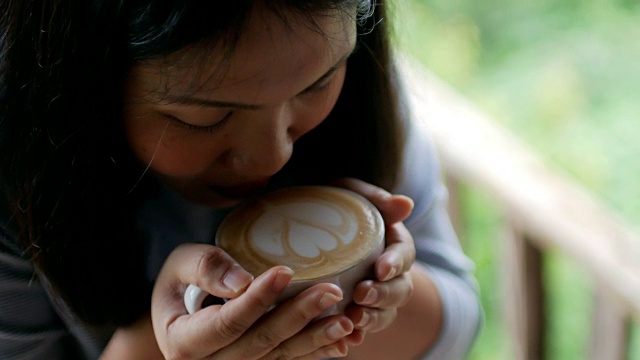 亚洲女人早上在咖啡馆喝一杯咖啡视频素材