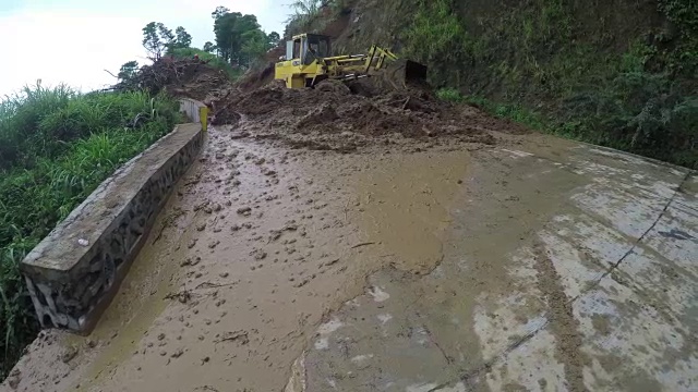 推土机在科迪勒拉悬崖的山路上推着泥石流碎片视频素材