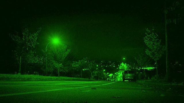 在城市夜视中，汽车从山上开下来视频素材