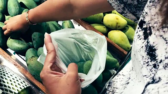 女人的手在超市买新鲜的有机食品，芒果视频素材