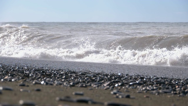 海上风暴。巨浪拍打着海岸，溅起水花。慢动作视频素材