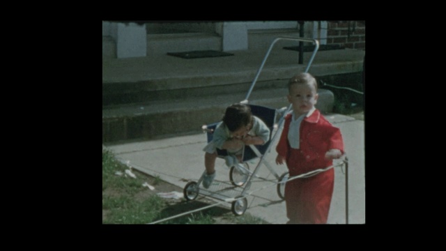 1954年，可爱的小孩穿着红色吊带裤四处闲逛视频素材