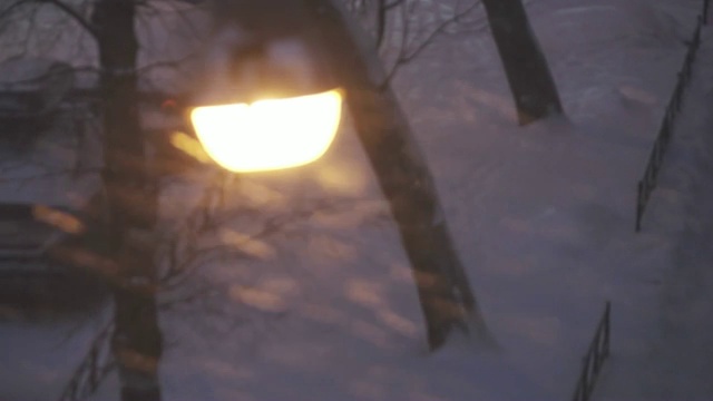 新年。在下雪时透过玻璃看到的街灯，在玻璃中反射的是装饰好的新的合适的圣诞树视频素材