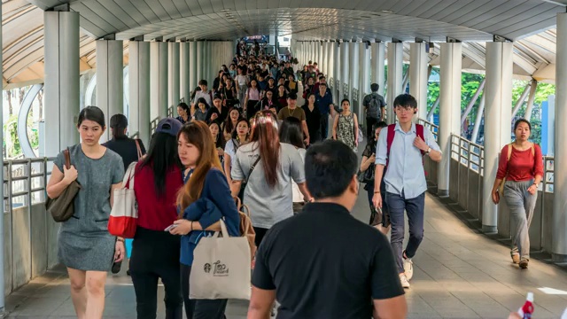 在曼谷BTS Chong Nonsi的高峰时刻，拥挤的人在高架地铁系统站的天桥上行走，交通和乘客旅行的概念视频素材