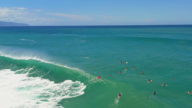 鸟瞰图蓝色海洋与冲浪和Bodyboarders等待正确的波浪视频素材