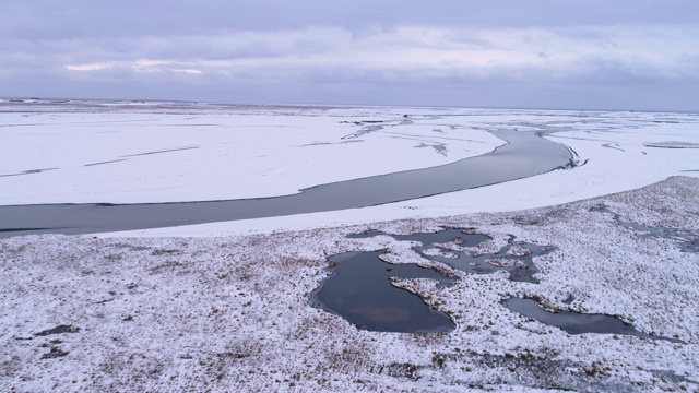 一对夫妇走向悬崖上的帐篷，俯瞰遥远的冰雪覆盖的风景，冰岛视频素材