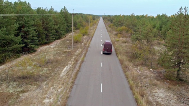 空中拍摄乡村公路上的汽车。鸟瞰图的老式黑色宝马在乡村道路上视频下载