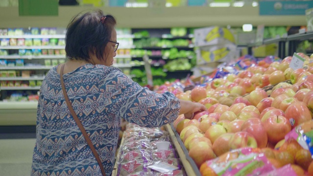 亚洲女人的手在超市挑选橘子视频素材