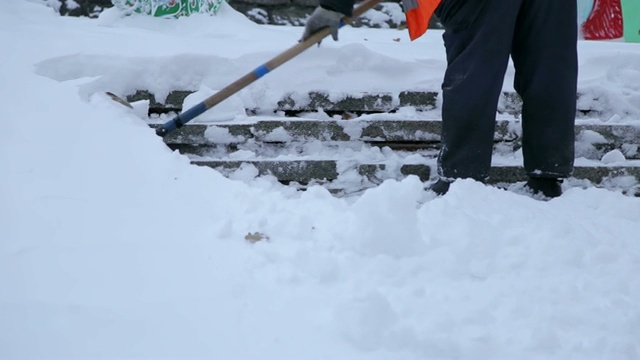 工人在冬天清扫道路上的积雪，清理道路免受暴风雪。视频素材