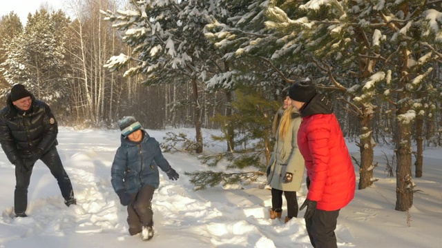 友好的家庭在雪地里打雪仗冬天散步视频素材