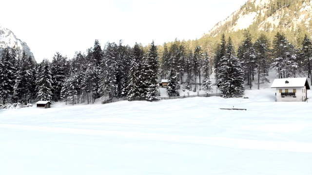 无人机的雪域冬季山谷和小屋视频素材