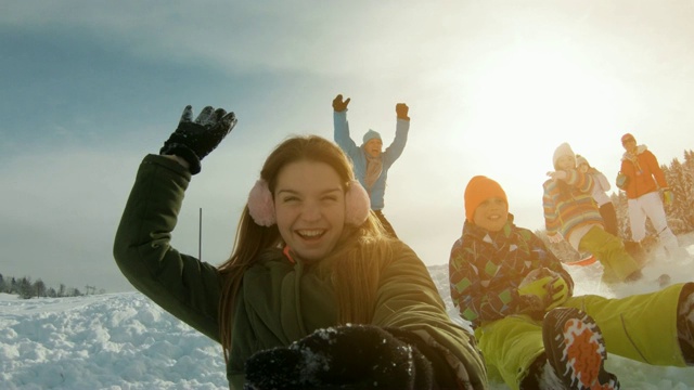 孩子们在一个美丽的冬日里玩雪橇视频素材