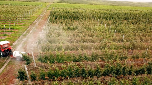 用拖拉机喷洒苹果树视频素材