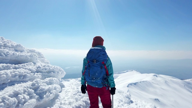 一位女性登山者在山顶眺望远方视频素材