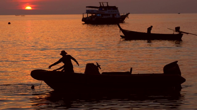 海上金色夕阳下的船的剪影视频素材