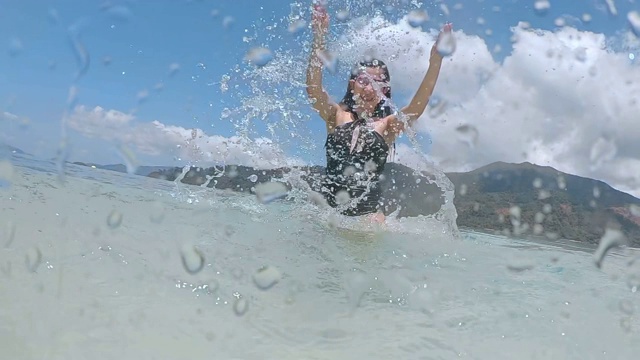 夏天亚洲女人有乐趣溅水和放松在海滩上超级慢动作视频素材