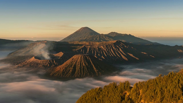 火山景观与移动在早上的雾海在布罗莫腾格塞默鲁国家公园视频下载