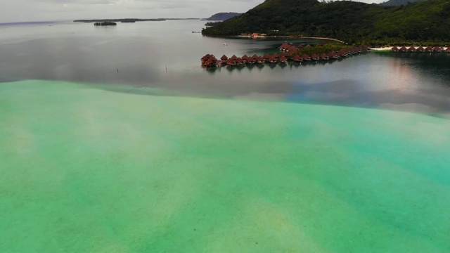 空中向前:在大理石绿色海洋的度假屋在波拉波拉山，法属波利尼西亚视频素材