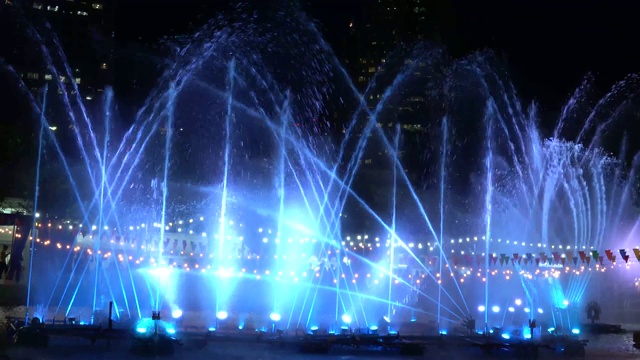 美丽的喷泉与光，稀薄的喷泉喷泉在夜空中升起，五颜六色的灯光喷泉在公园，4k视频素材