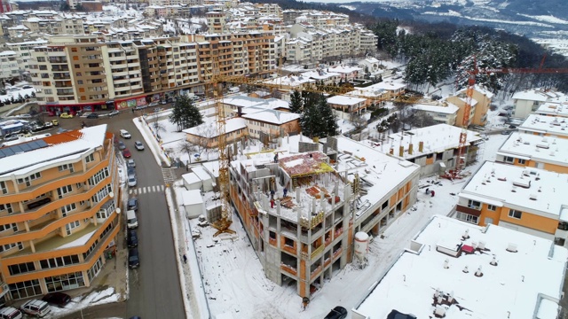 建筑工地鸟瞰图，平移拍摄，高空视角，冬季，建筑起重机，住宅区，建筑企业，视频素材