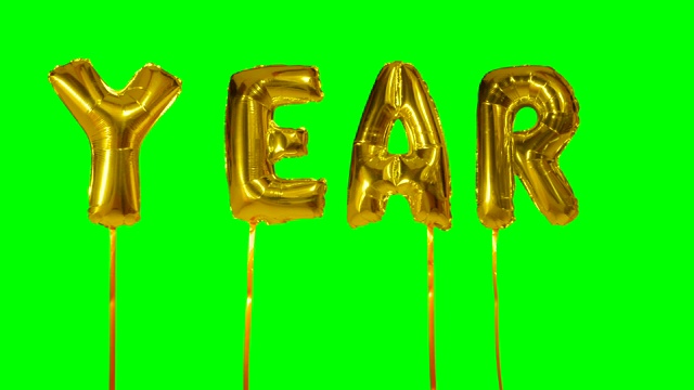 单词年从氦气金色气球字母漂浮在绿色屏幕上视频下载