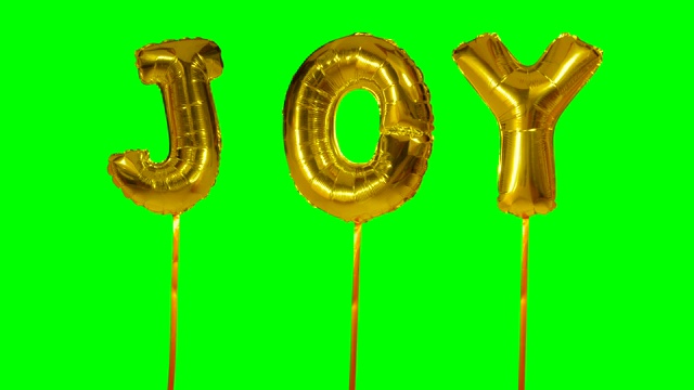 单词喜悦从氦气金色气球字母漂浮在绿色屏幕上视频下载