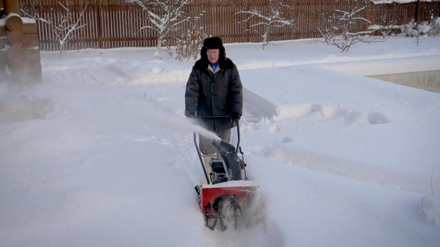 冬天，一个男人在清理路上的积雪视频素材