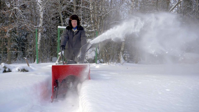 冬天，人们用除雪机清理森林里的积雪视频素材