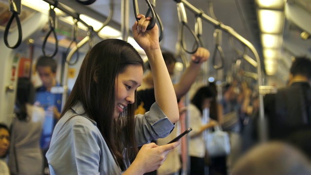 年轻的亚洲女人在地铁里打电话视频素材