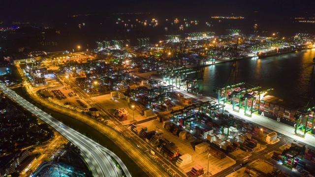 夜光飞行在新加坡集装箱码头港口交通道路空中全景，4k时间间隔视频素材