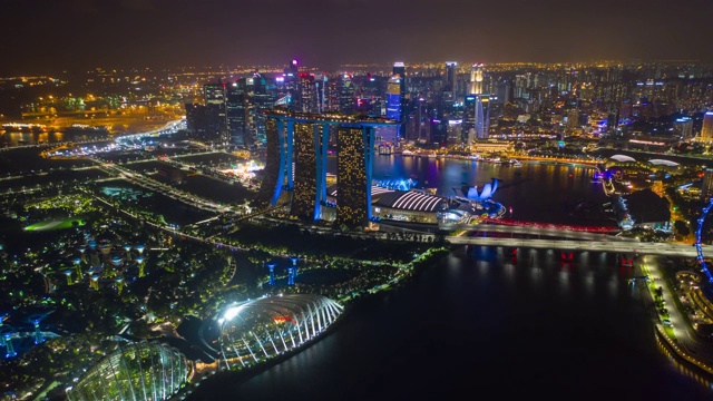 夜间灯光照亮了新加坡城市上空著名的酒店花园湾航拍全景，时间跨度为4k视频素材