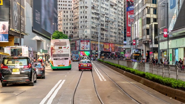 在香港铜锣湾的行人与历史电车的背景视频素材