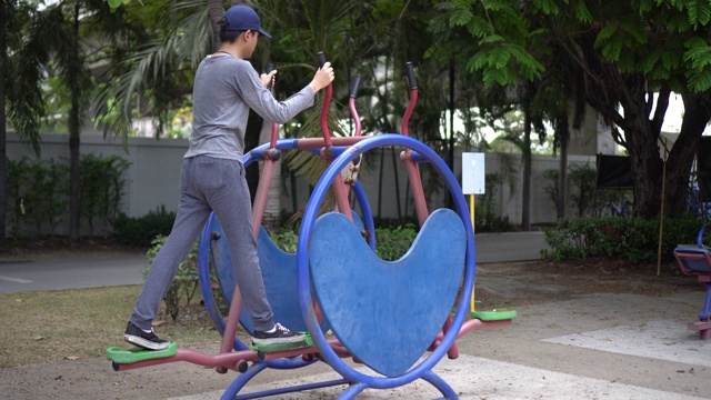 那个男孩正在公园里锻炼身体。视频素材