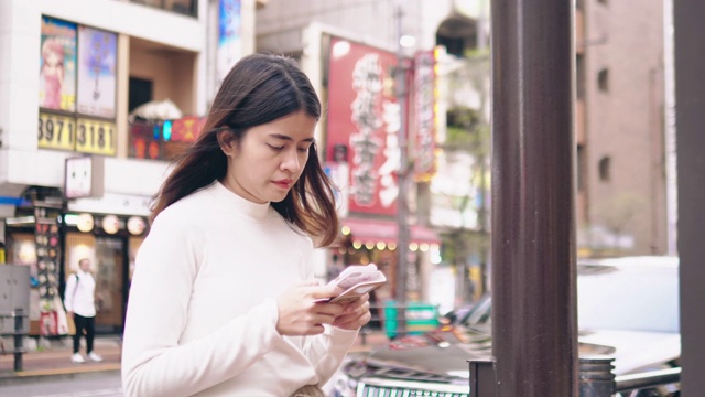 一位年轻女子在东京等出租车。视频素材