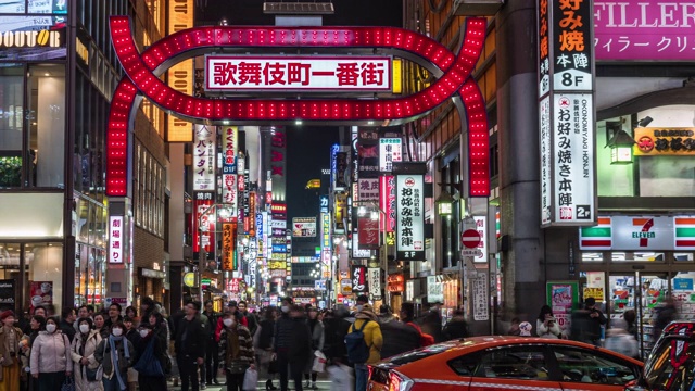 4K日本东京新宿，歌舞伎町夜晚的一段时间，人群不明，行人行走在马路上，车水马龙。日本霓虹街文化与购物概念视频素材