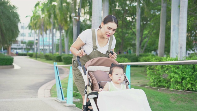 亚洲母亲和她的小女儿在公园散步，幸福的家庭。视频素材