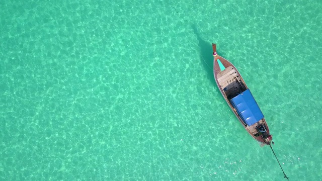 鸟瞰图或俯视图的长尾船是漂浮在翡翠海上视频素材