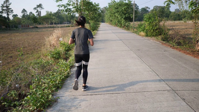 这名年轻女子在日落时分慢跑，慢镜头用4k拍摄视频素材