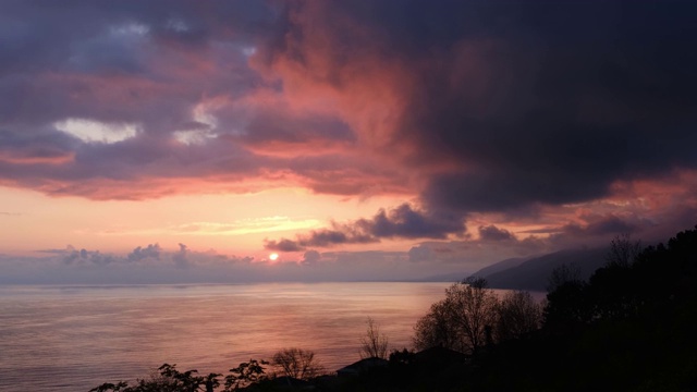 夕阳照在海面上。美丽的日落。天空中有大片的云。野生动物。从海岸的全景。视频素材