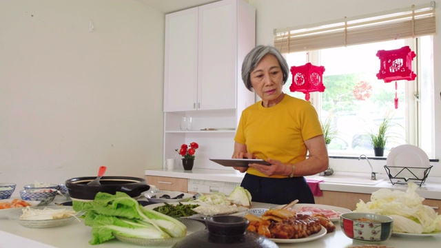 中国老妇人在厨房准备新年食物视频素材