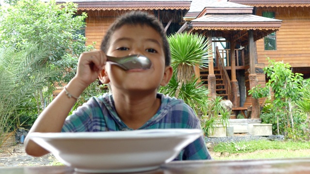 亚洲小男孩在家里吃米饭视频素材