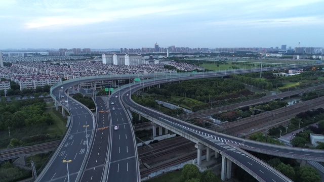 无人机的高速公路多层次交叉道路与移动的汽车在日落。汽车在多层路口行驶，是城市的概念。苏州城市,中国。视频素材