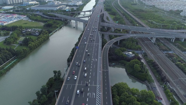 无人机的高速公路多层次交叉道路与移动的汽车在日落。汽车在多层路口行驶，是城市的概念。苏州城市,中国。视频素材