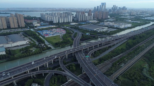 无人机的高速公路多层次交叉道路与移动的汽车在日落。汽车在多层路口行驶，是城市的概念。苏州城市,中国。视频素材