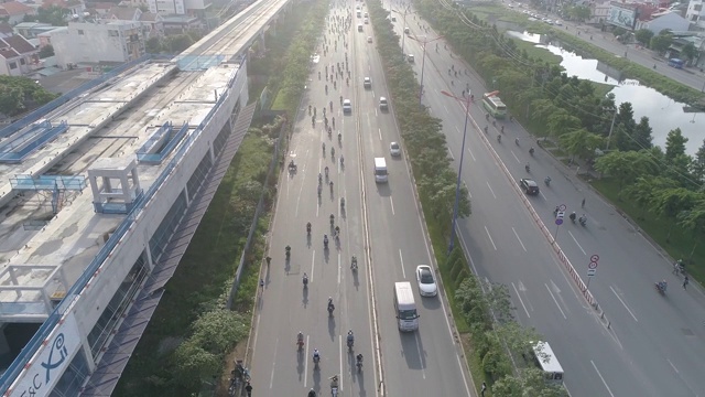 航拍:镜头跟随繁忙的越南交通和地铁项目。视频下载