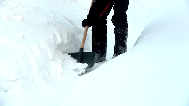 一个人在清理用铲子铲出的雪道视频素材