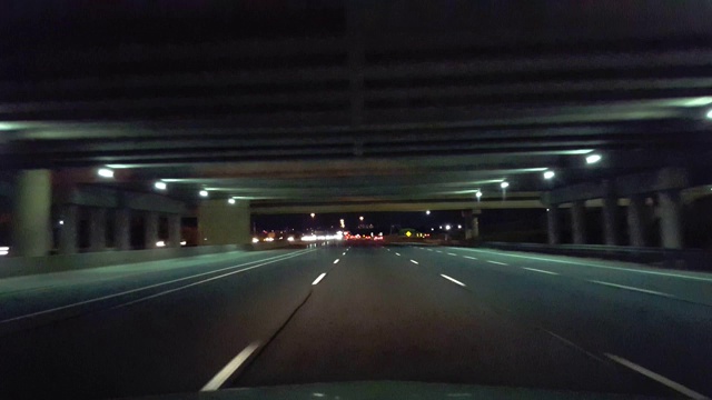 在夜晚驾驶城市公路。司机观点POV城市州际公路晚上。Freeway或Motorway或Turnpike或Expressway。视频素材