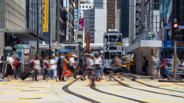 4K时间镜头，一群交通车辆和行人正穿过香港中区黄色人行横道视频素材