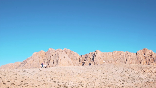 一位女登山者正走向一座山的顶峰视频素材